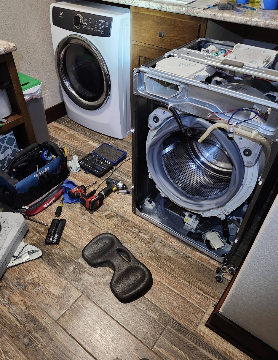 Burns Appliance Repair technician working on a washer and dryer
