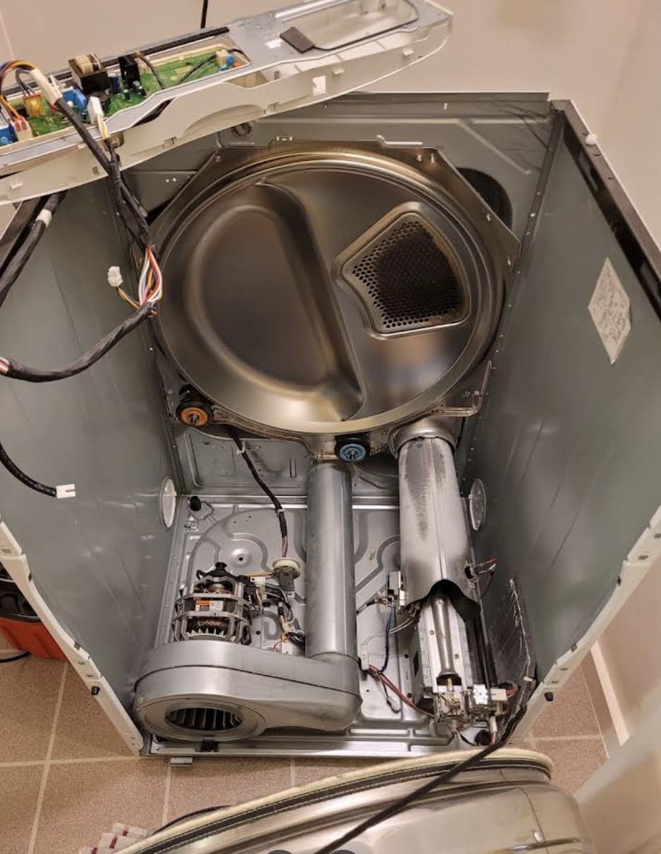Dryer drum and heating components exposed during repair